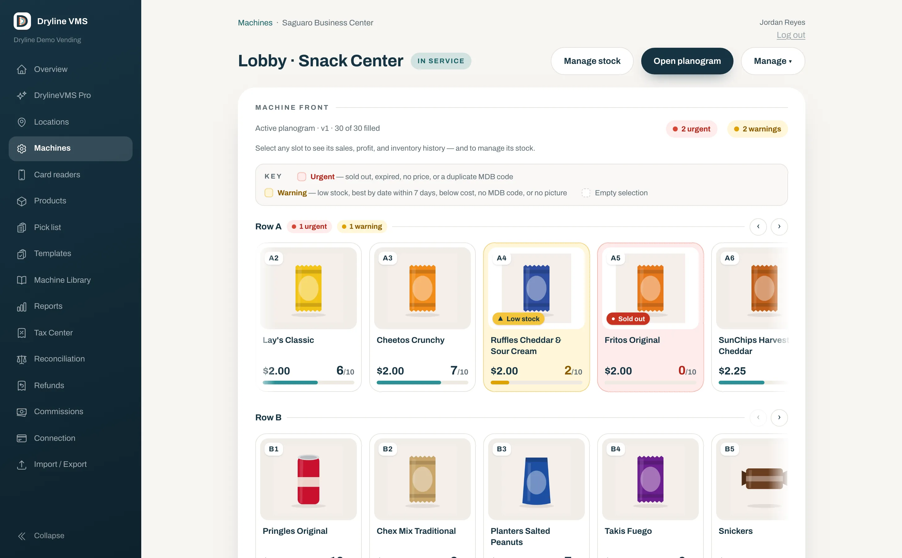 A vending machine front in Dryline VMS: thirty slots with product art, prices, and stock levels, the sold-out slots marked red and the low ones yellow